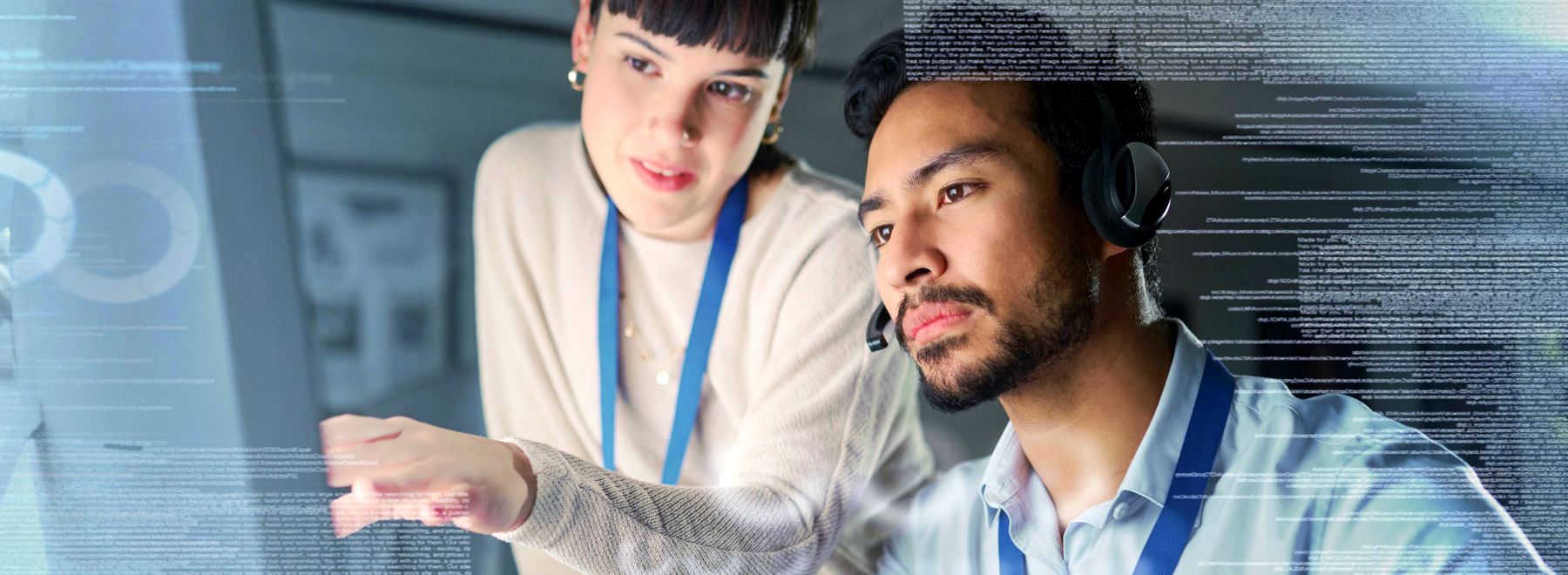 male and female call center reps with headphones sitting in front of monitors assisting customers online