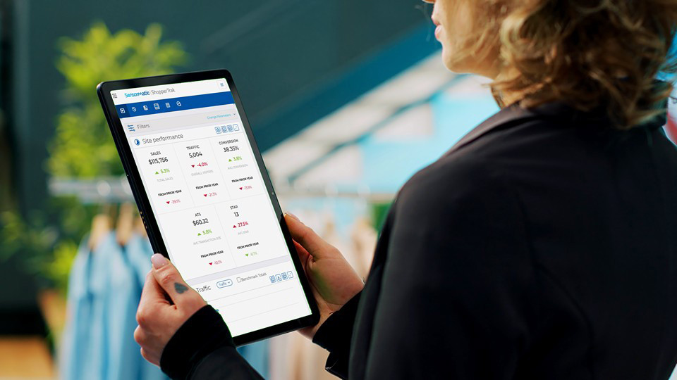 retail store manager reviewing analytics data on an electronic tablet