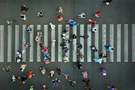 overhead shot of people crossing city street