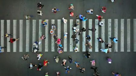 overhead shot of people crossing city street